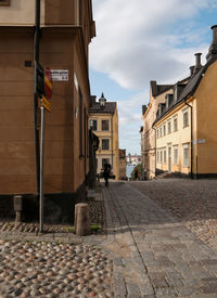 Street amidst buildings in city against sky