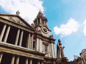 Low angle view of building against cloudy sky