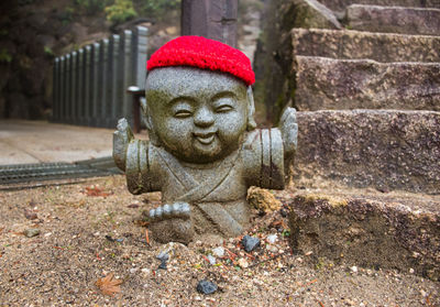 Close-up of statue against stone wall