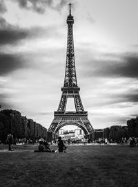 Eiffel tower against cloudy sky
