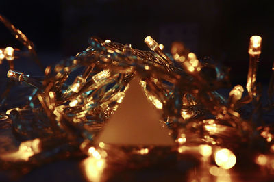 Close-up of illuminated christmas lights on table