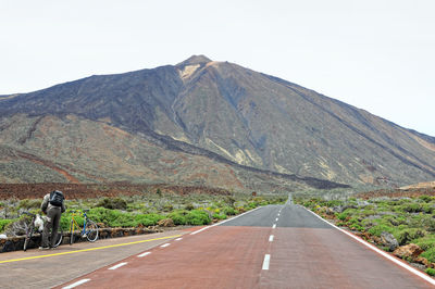 Empty road against el teide volcano at tenerife