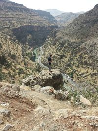 Rear view of woman standing on mountain