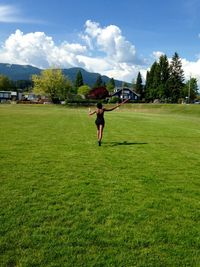 People walking on grassy field