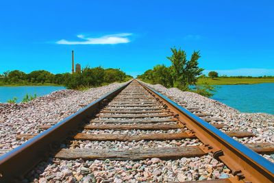 View of railroad tracks against blue sky