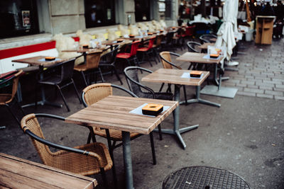 Empty chairs and tables in row