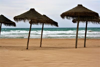 Gazebo on beach against sky