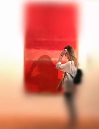 Side view of woman with red umbrella