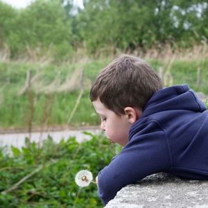 Side view of boy on field
