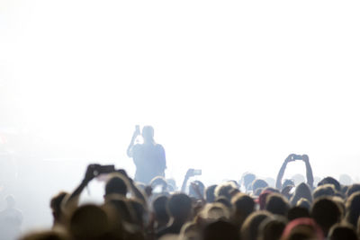 Concert crowd partying at live concert. bright stage lights, space for text