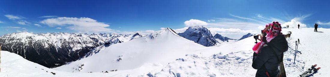 Panoramic view of snowcapped mountains against sky