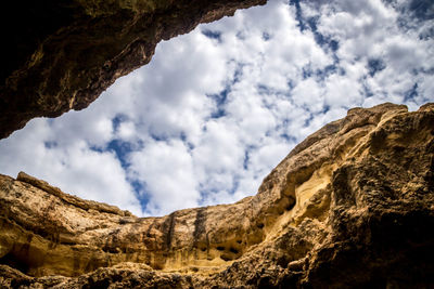 Low angle view of rock formations against sky