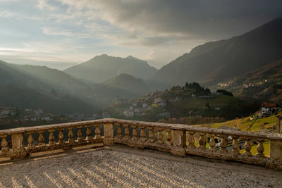 Stone square with balustrade overlooking a small mountain village