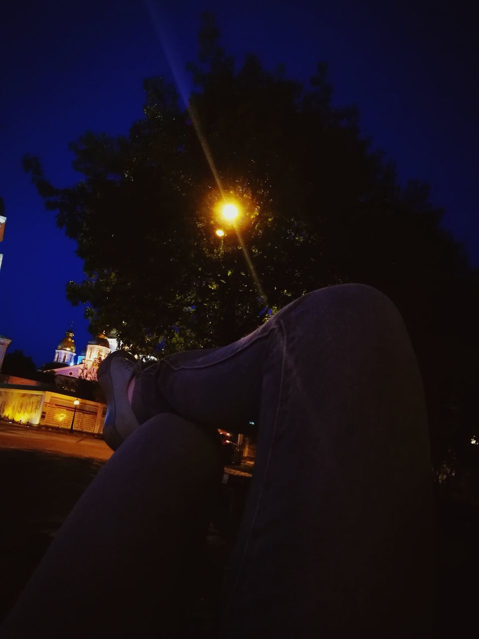 night, one person, real people, human leg, leisure activity, illuminated, relaxation, sitting, low section, outdoors, sky, human body part, nature, tree, close-up, people