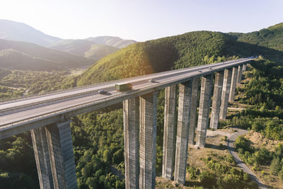 Bridge over mountains against sky