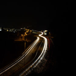 High angle view of light trails on road at night