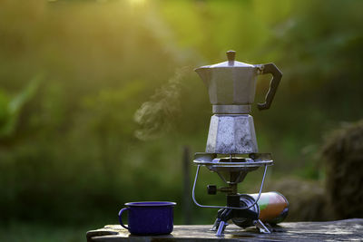 Antique coffee pot on the gas stove for camping when the sun rises in the morning.