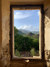 Scenic view of mountains seen through window