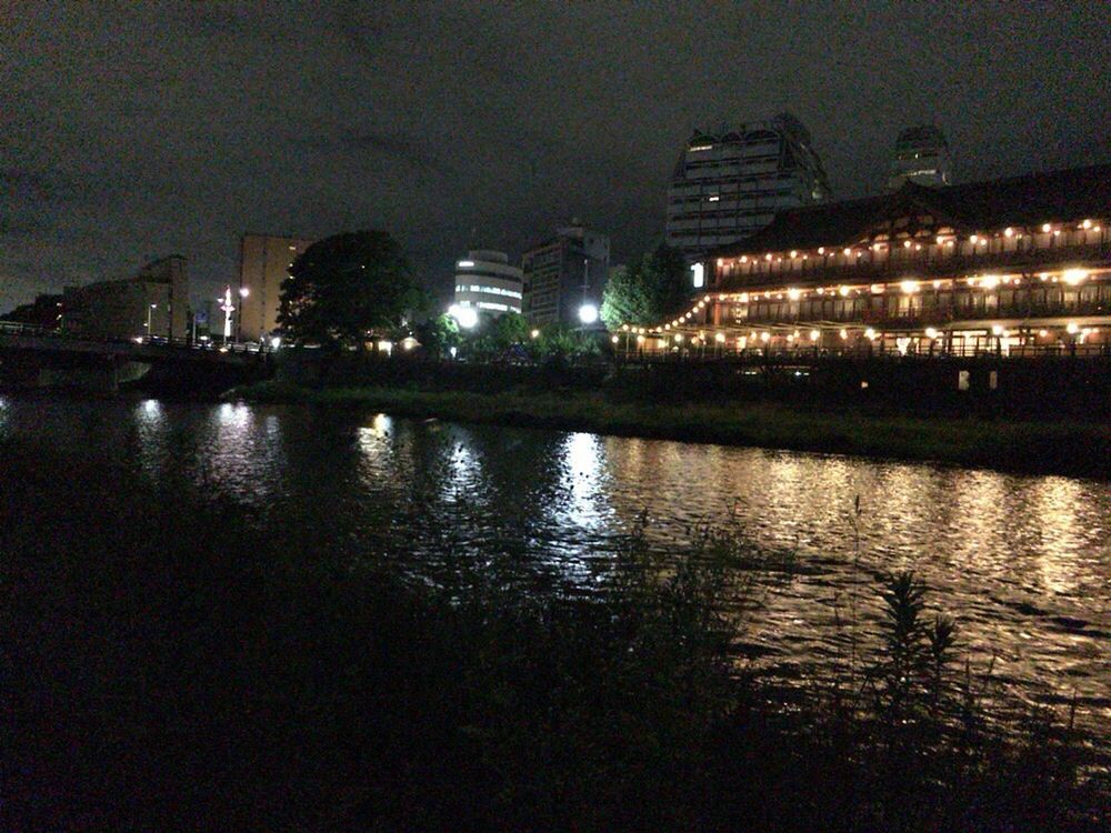 VIEW OF ILLUMINATED CITYSCAPE AT NIGHT