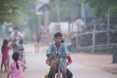 Rear view of people riding horse