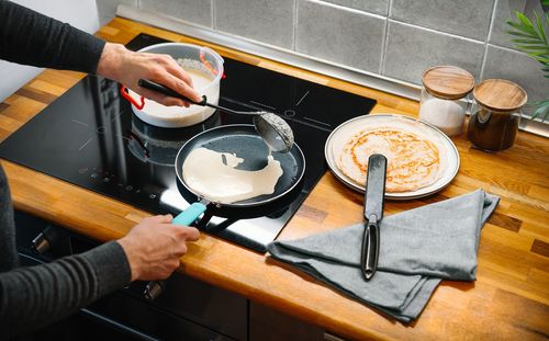 High angle view of person preparig pancakes cup in kitchen at home