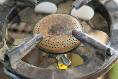 Close-up of an old, rusted and forgotten gas stove