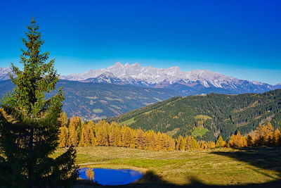 Scenic view of mountains against clear blue sky