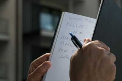 Close-up of woman hand with text