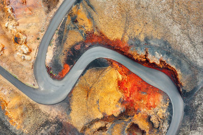 High angle view of rusty metal on rock