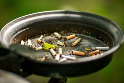 Close-up of cigarette butts in ashtray