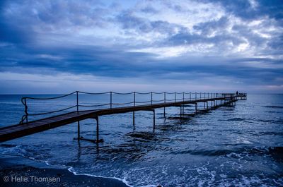 Pier over sea against sky