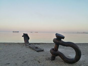 Close-up of sea against clear sky at sunset