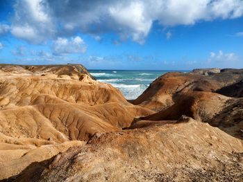 Scenic view of sea against cloudy sky