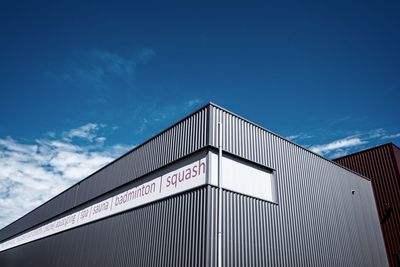 Low angle view of text on building against sky