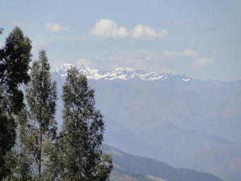 Scenic view of mountains against cloudy sky