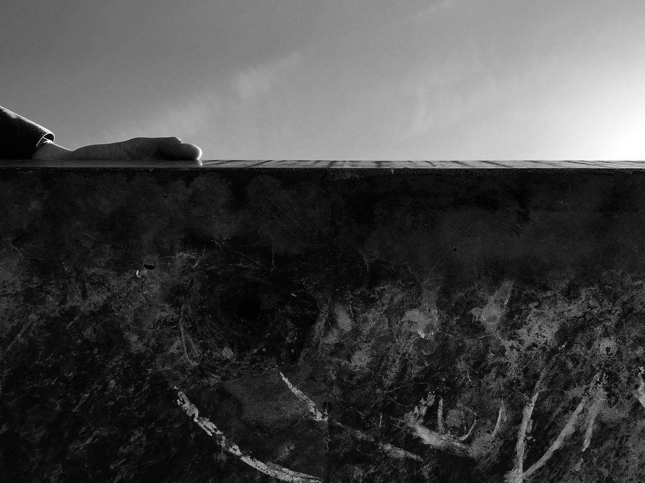 CLOSE-UP OF ABANDONED WALL AGAINST SKY