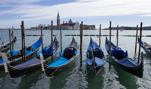 Gondolas moored on grand canal with church of san giorgio maggiore in background