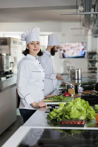 Portrait of smiling chef preparing food in restaurant kitchen