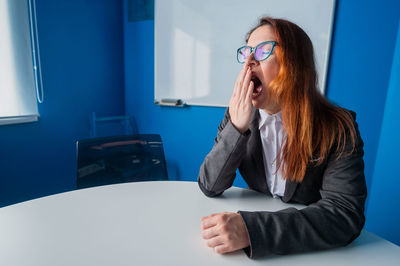 Side view of woman using mobile phone