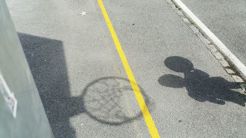 High angle view of shadow of man on road