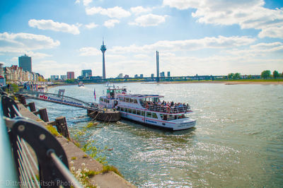 Boats in river with city in background