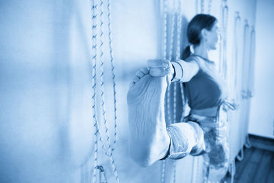 Rear view of woman standing against wall