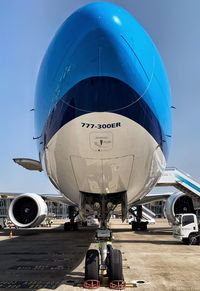 Airplane on airport runway against blue sky