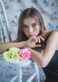 Portrait of young woman holding rose bouquet