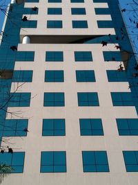 Low angle view of modern building against blue sky