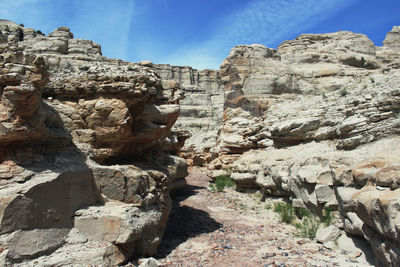 Low angle view of rocks on mountain against sky