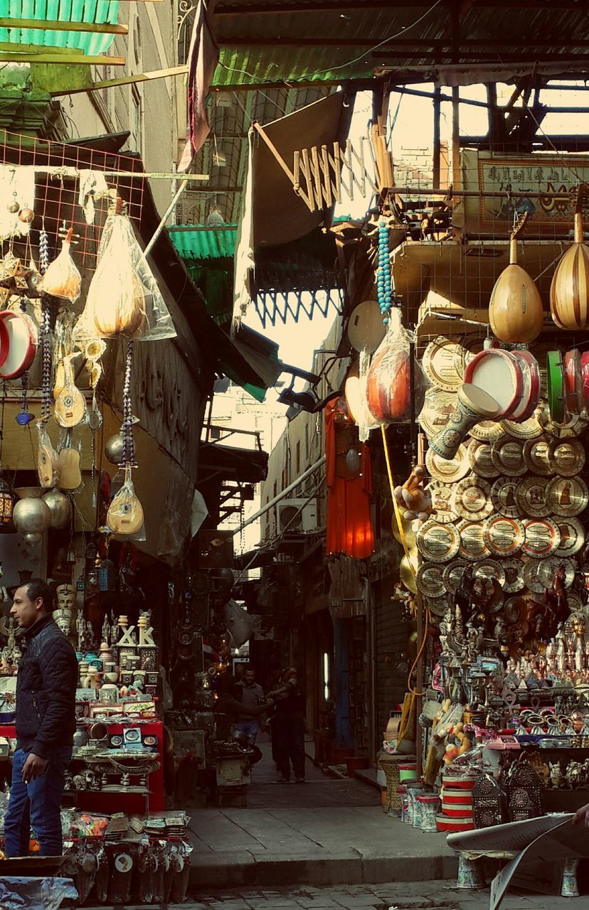 market, retail, hanging, building exterior, market stall, for sale, architecture, built structure, lantern, store, street, decoration, large group of objects, men, incidental people, outdoors, small business, lighting equipment, variation