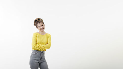 Portrait of a smiling young woman against white background