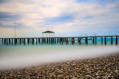 Pier over sea against sky