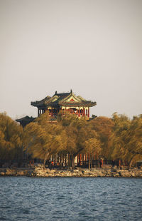 Building at waterfront against clear sky